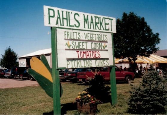 Pahls Market sign with fruits, vegetables, sweet corn, tomatoes and pickling cukes