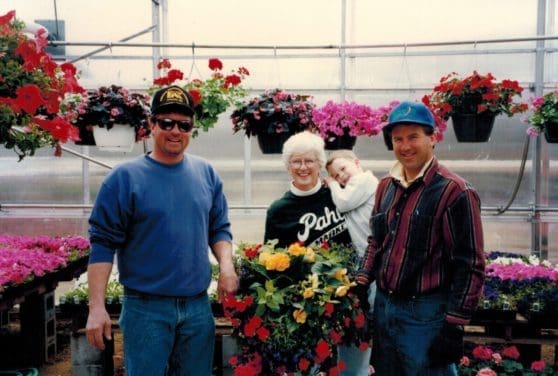 Gary, Joanne, Jack and Gary in Greenhouse with flowers